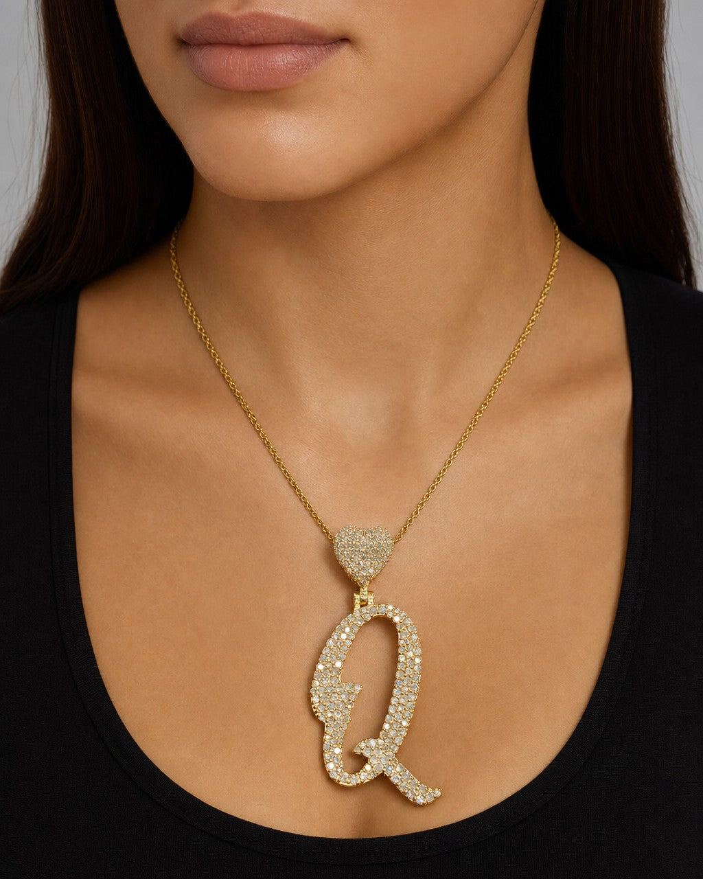 Female model wearing 14k Initial Q Script Heart Pendant