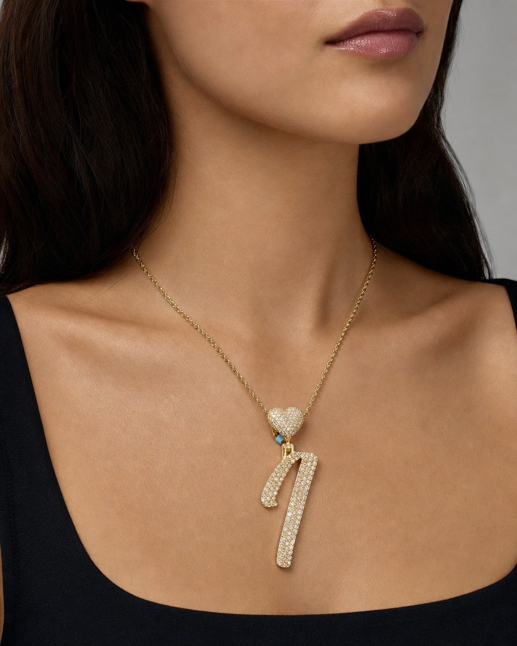 Female model wearing 14k Initial I Script Heart Pendant