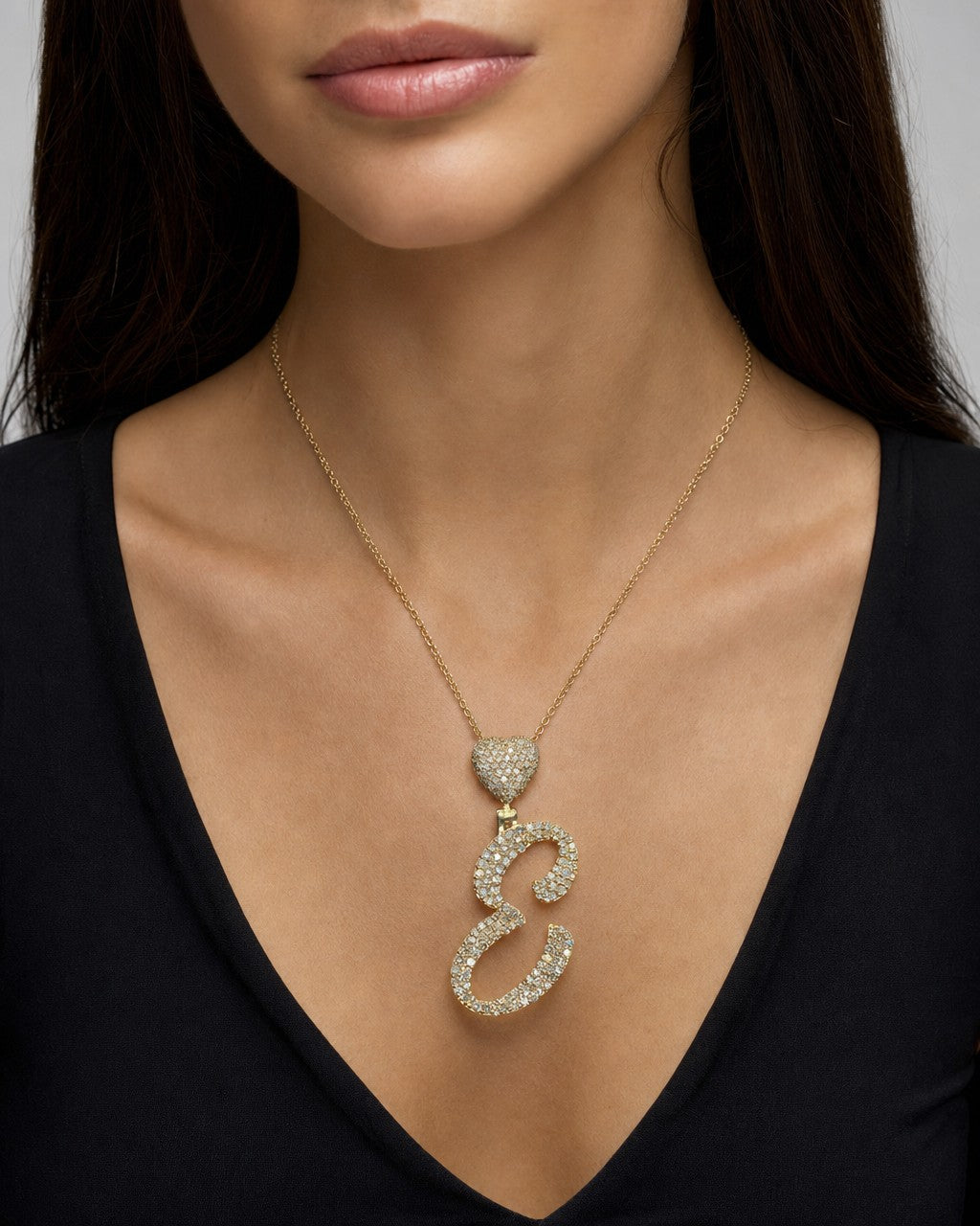 Female model wearing 14k Initial E Script Heart Diamond Pendant