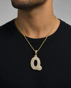 Male model wearing 14k Initial Q Bubble Pendant
