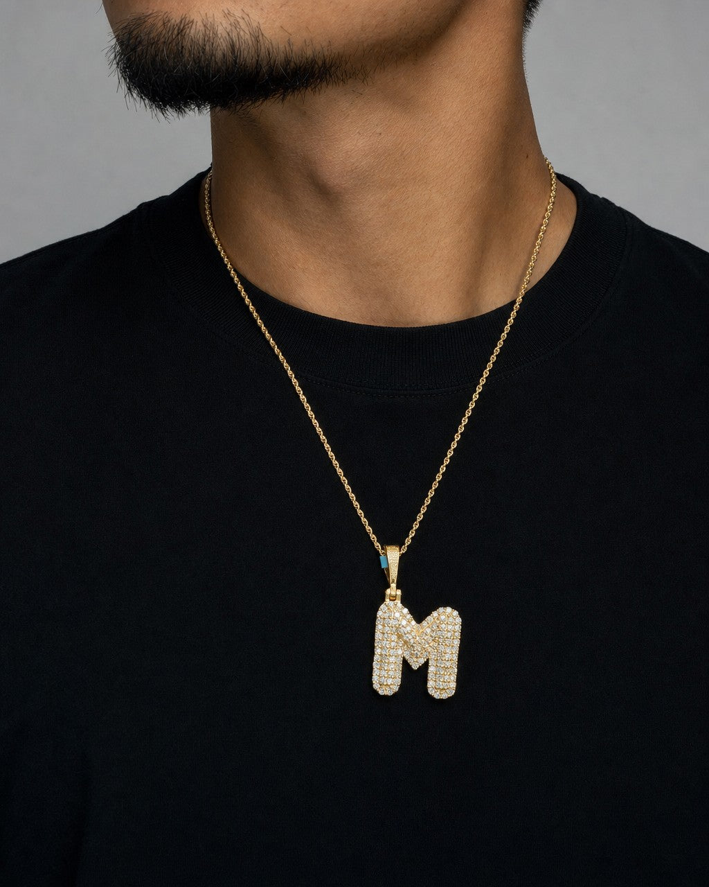 Male model wearing 14k Initial M Bubble Pendant