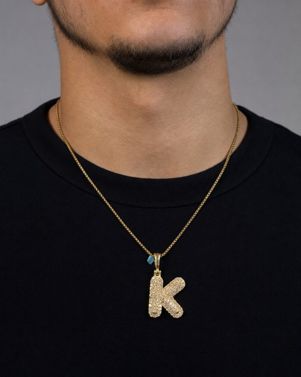 Male model wearing 14k Initial K Bubble Pendant