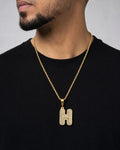 Male model wearing 14k Initial H Bubble Pendant
