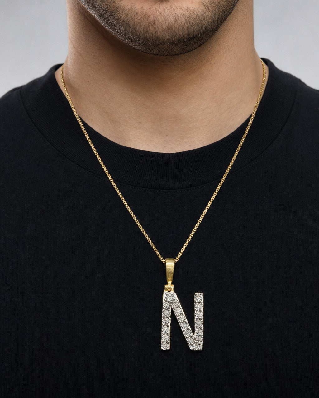 Male model wearing 14k Single Stone Initial N Pendant