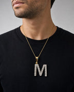 Male model wearing 14k Single Stone Initial M Pendant