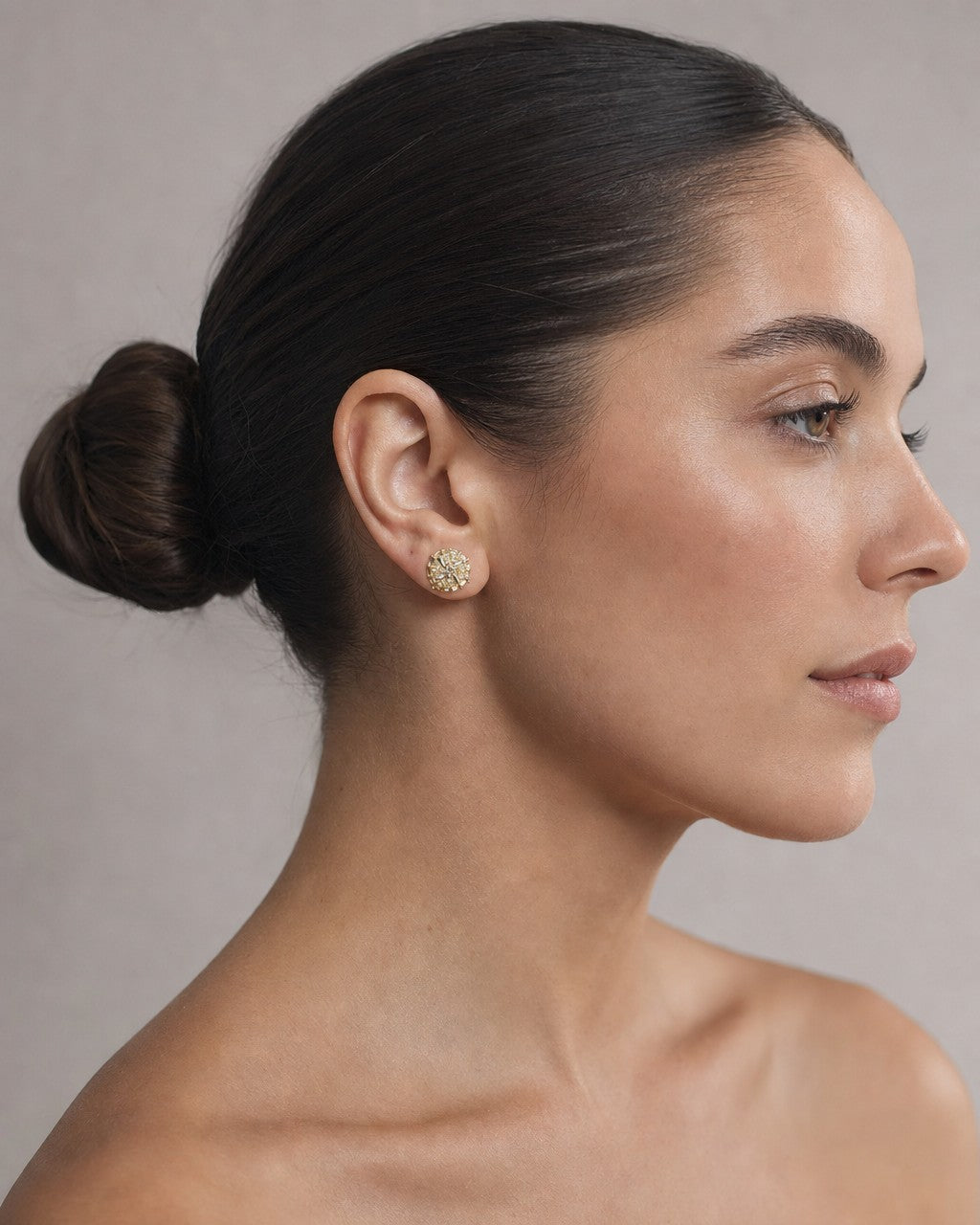 Female model wearing 14K Circle Spiral Diamond Baguette Earrings
