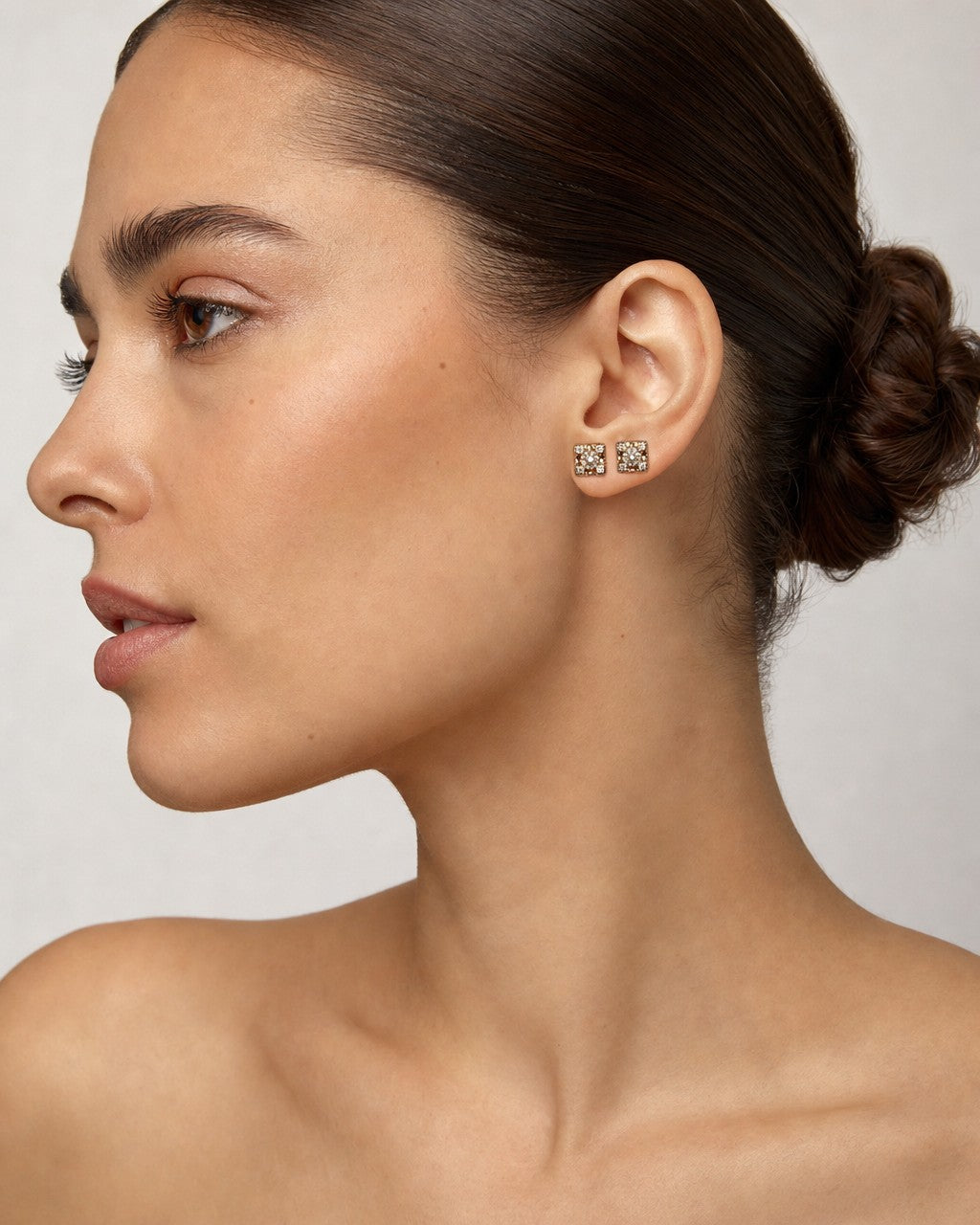 Female model wearing 14K Castle Diamond Earrings Small