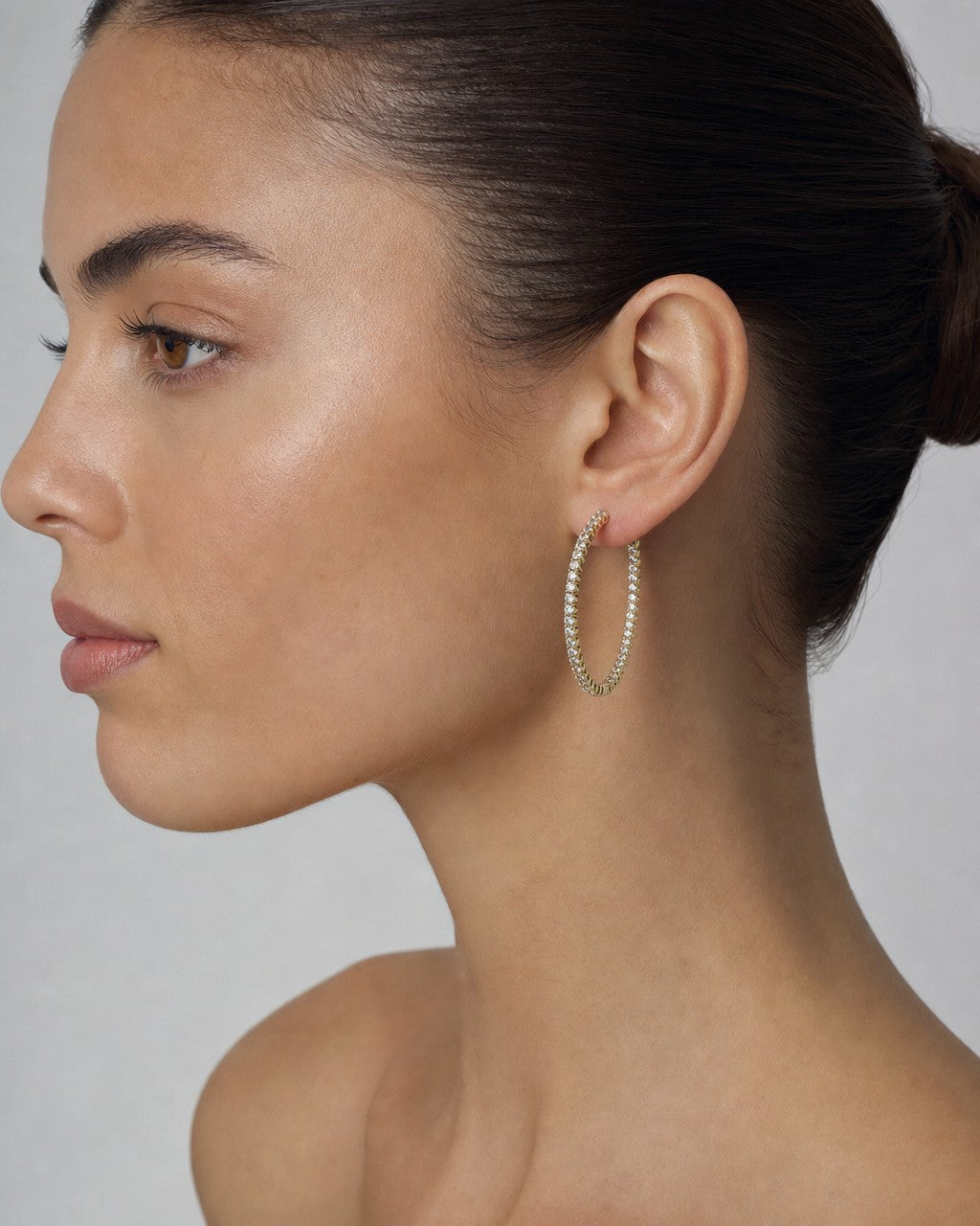 Female model wearing 10K Large Circle Hoop Diamond Earrings