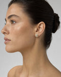 Female model wearing 14K Triangle Large Center Stone Diamond Earrings