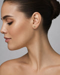 Female model wearing 14K Teal Center Stone Evil Eye Diamond Earrings