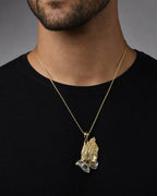 Male model wearing 14K Praying Hands Pendant 1.5"