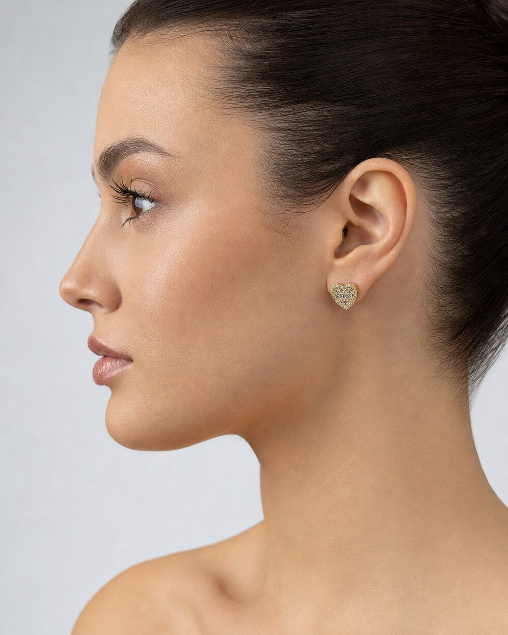 Female model wearing 14K Heart Diamond Baguette Earrings