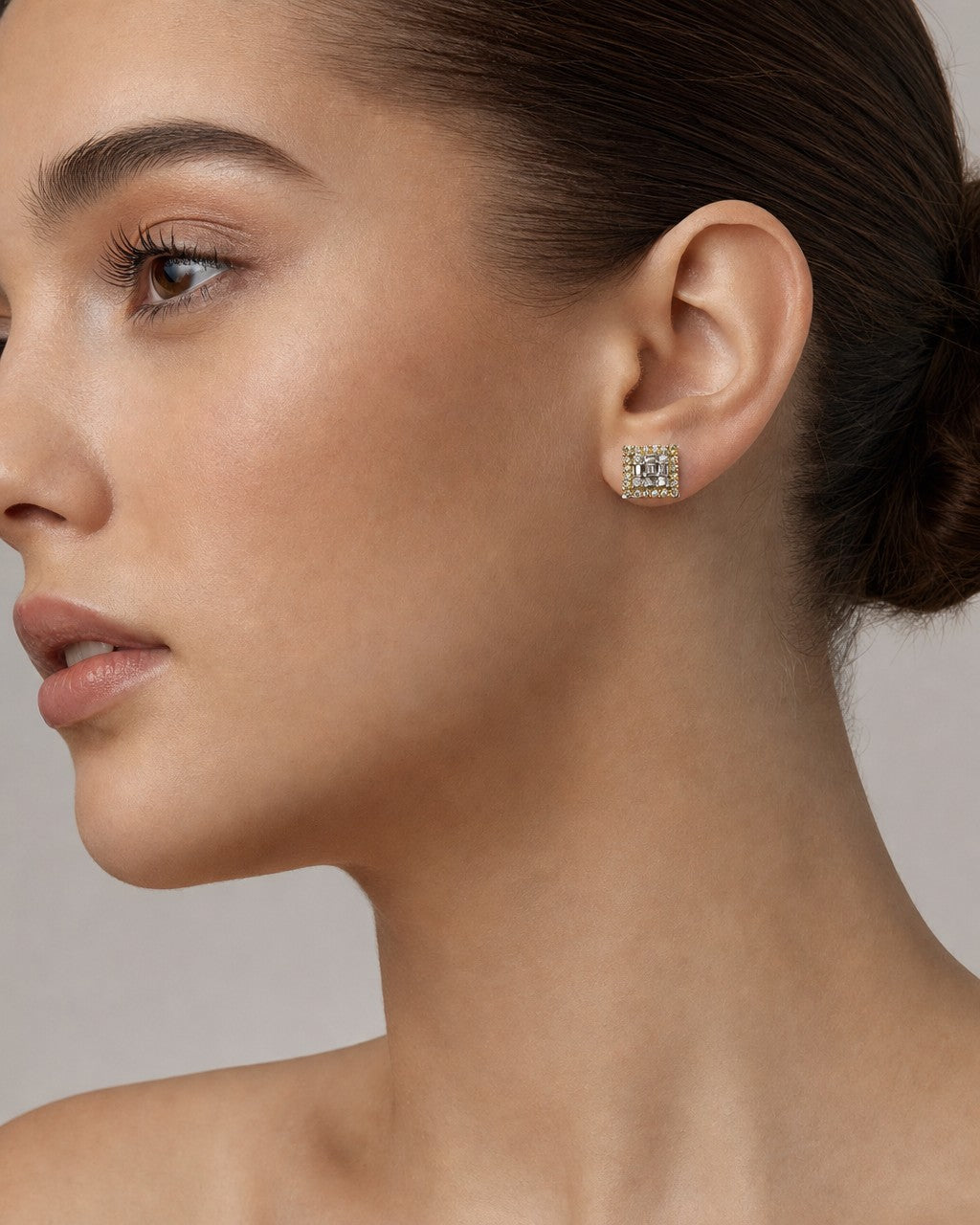 Female model wearing 14K Curved Square Diamond Baguette Earrings
