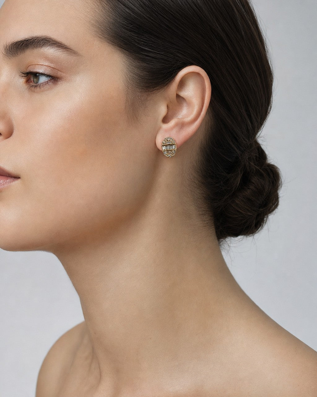 Female model wearing 14K Oval Diamond Baguette Earrings