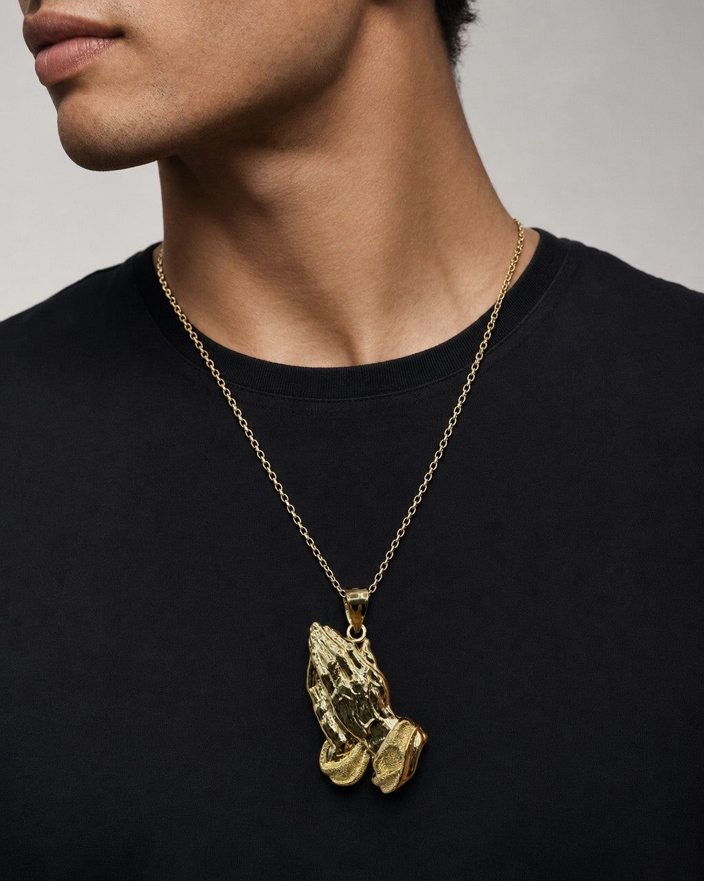 Male model wearing 14K Praying Hands Pendant 1.5"
