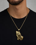 Male model wearing 14K Praying Hands Pendant 1.8"