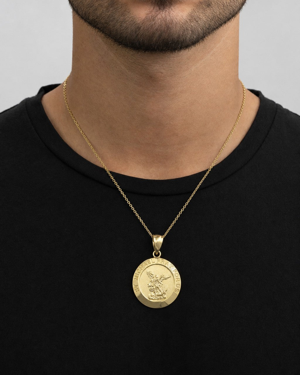 Male model wearing 14K Saint Michael Round Pendant