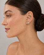 Female model wearing 14K Heart Solid Rim Diamond Earrings