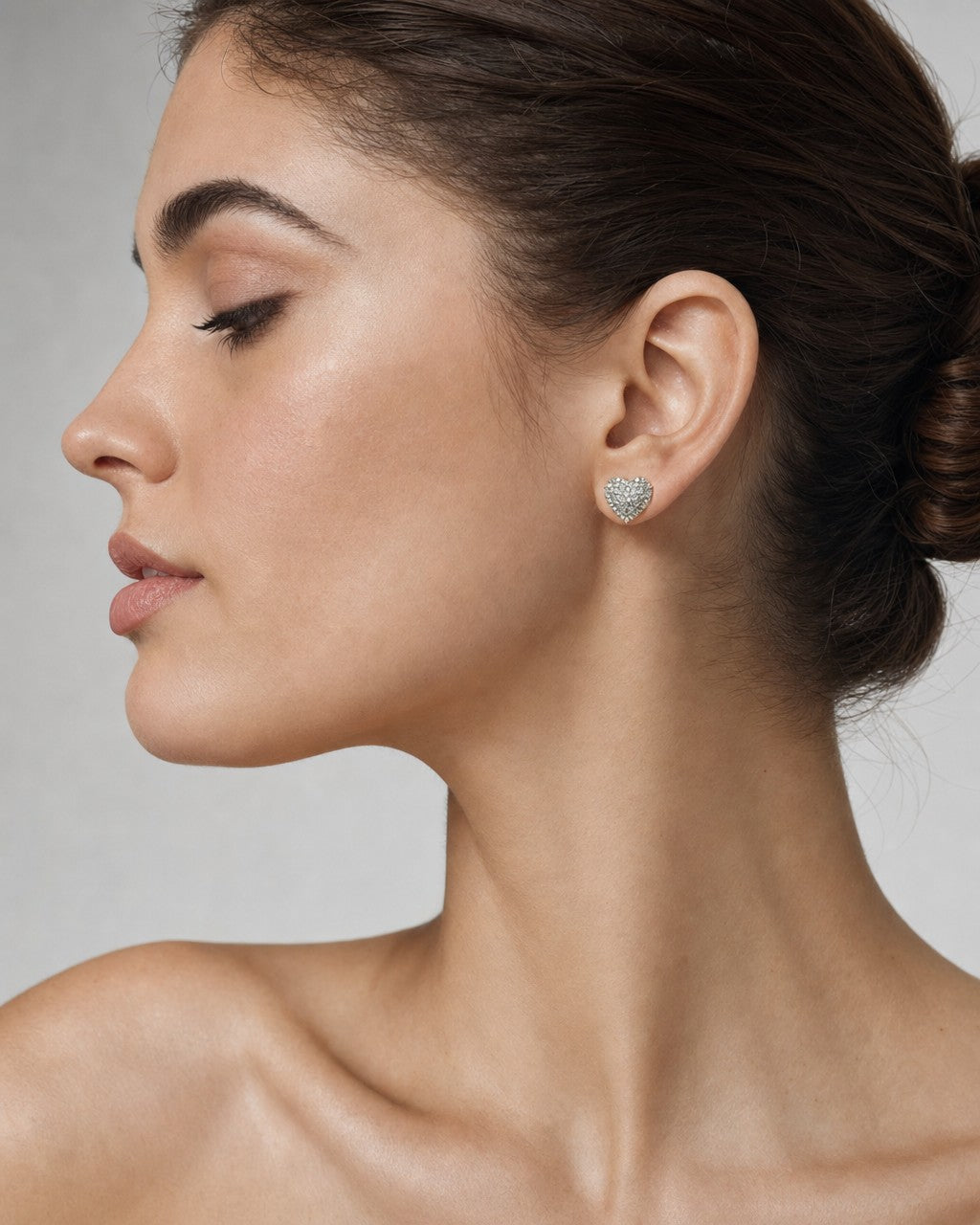 Female model wearing 14K Heart Halo Diamond Earrings