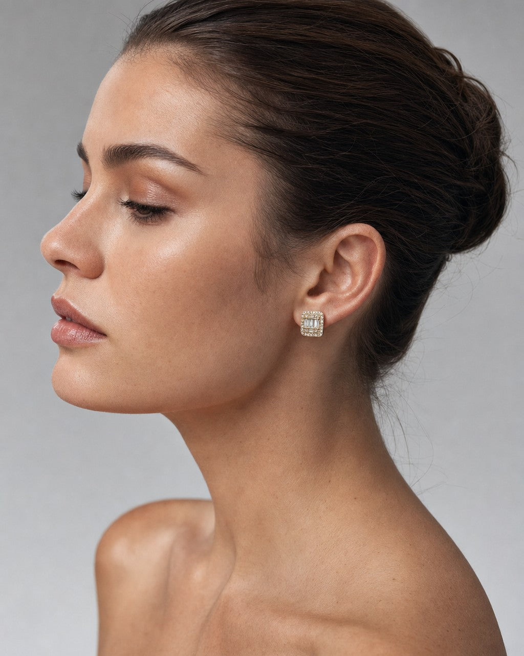 Female model wearing 14K Large Rectangle Halo Diamond Baguette Earrings