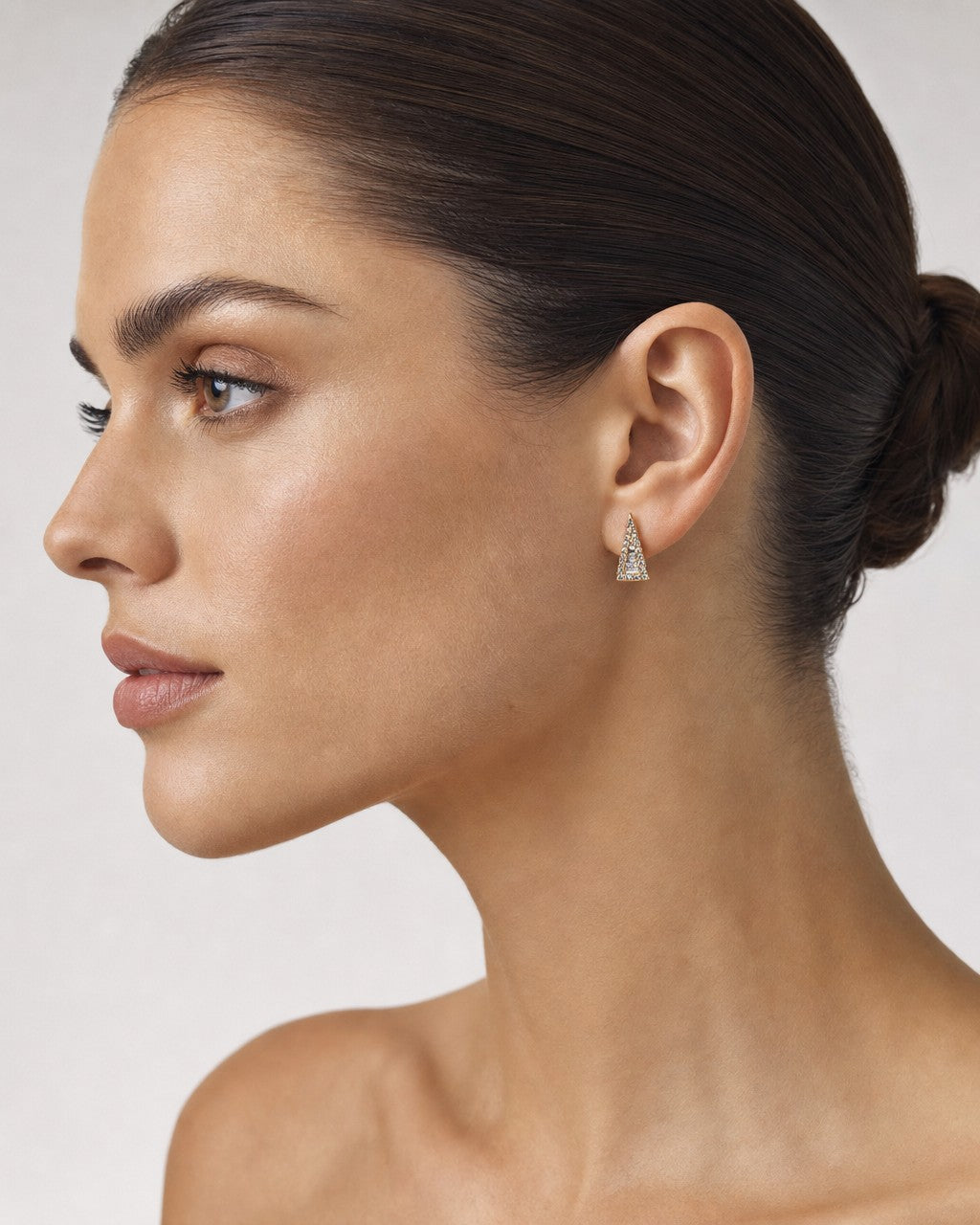 Female model wearing 14K Large Isosceles Triangle Diamond Baguette Earrings