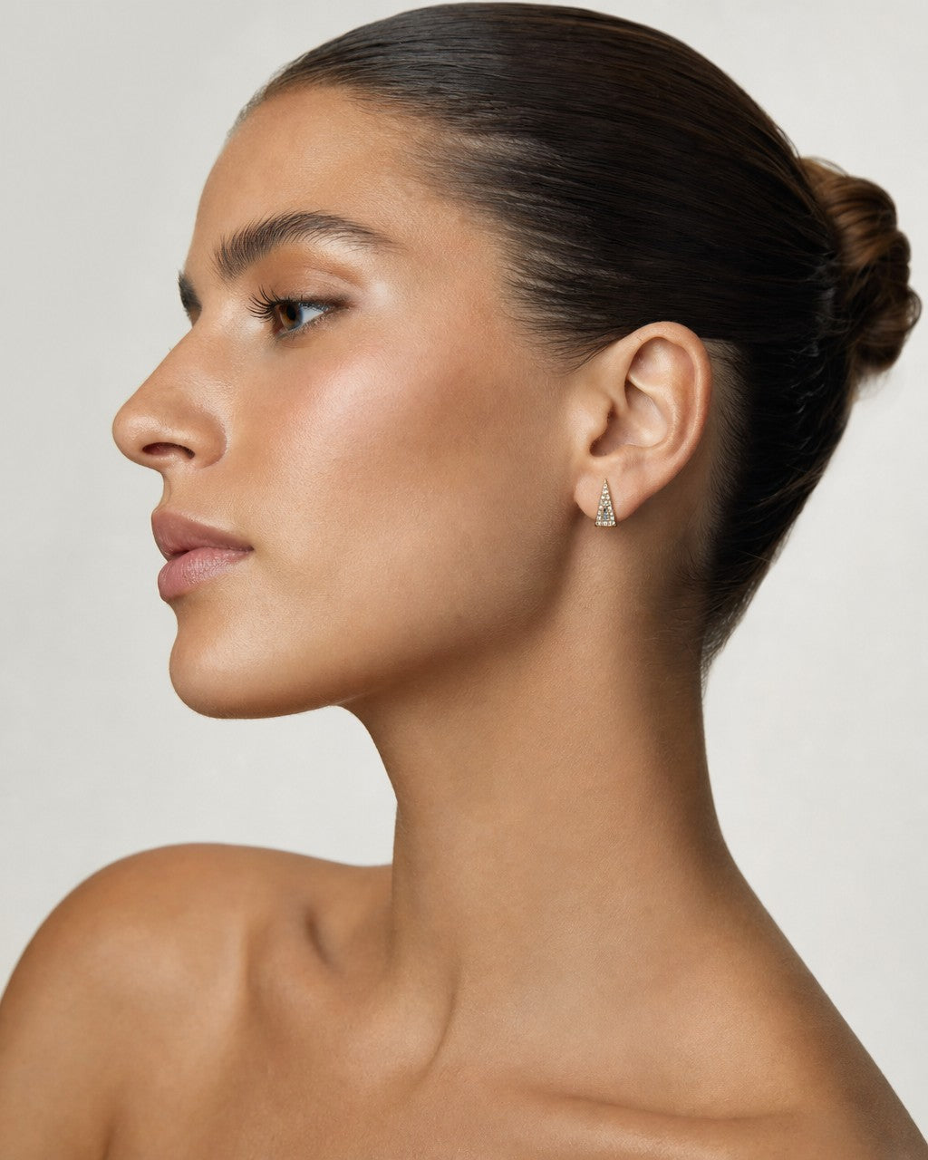 Female model wearing 14K Small Isosceles Triangle Diamond Baguette Earrings