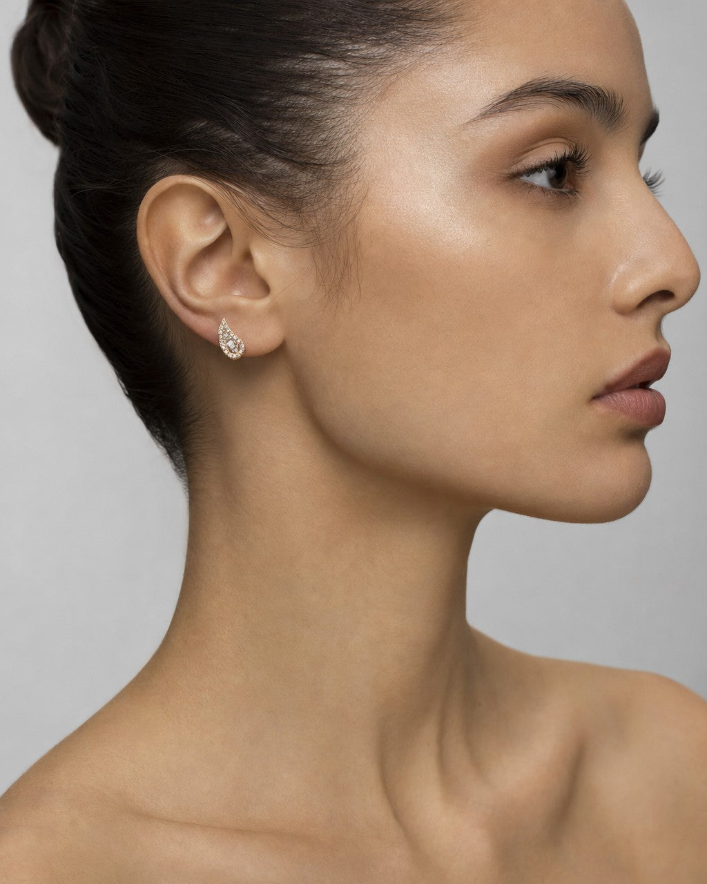 Female model wearing 14K Small Tear Shape Diamond Baguette Earrings