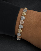 Male model wearing 10K 9MM Multi-Color Hearts Link Diamond Baguette Bracelet 6.5-7.5