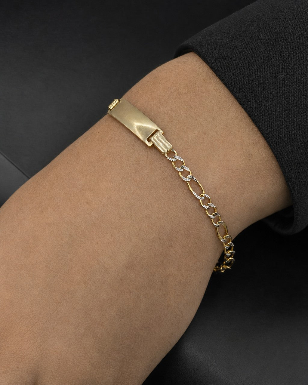 Male model wearing 10K Custom Name Plate Two-Tone Figaro Link Baby Bracelet