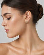 Female model wearing 14K Simple Heart Earrings